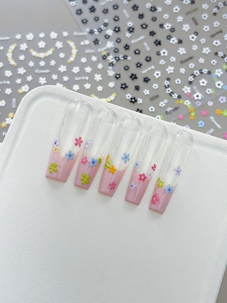 3D embossed mini floral nail stickers with charming cartoon blooms on press on nails, close up look