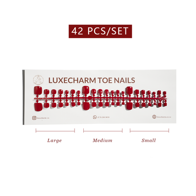 Display of LuxeCharm toe nails with size labels on a white background. Classic Red press-on toenails 42 piece set — classic red pedicure