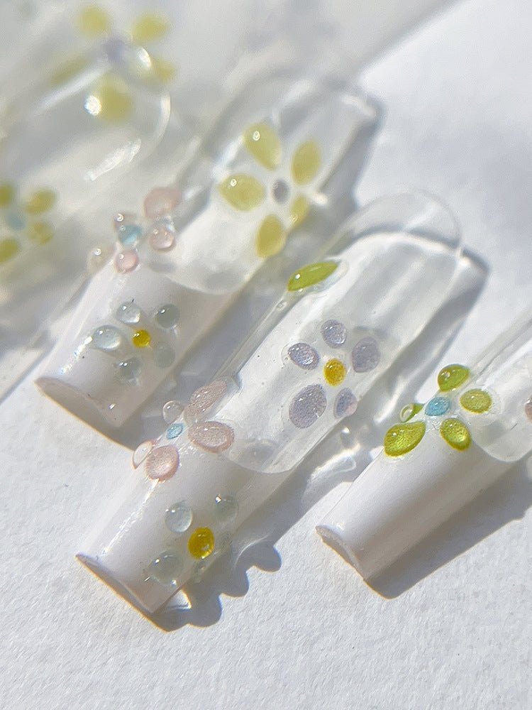 Minimal cartoon bloom jelly flower 3D nail art sticker on press on nails, close up look angle 2