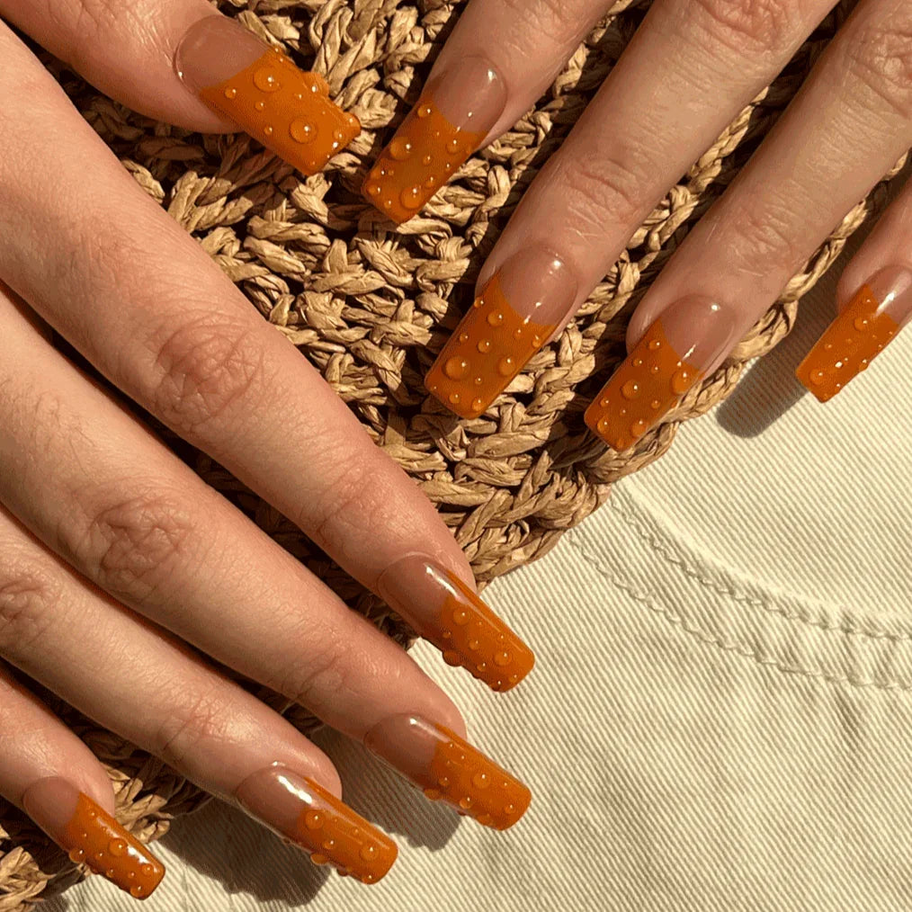 orange waterdrop 3D nails. Luxury press on nails. On-hand image. 9 Press-ons