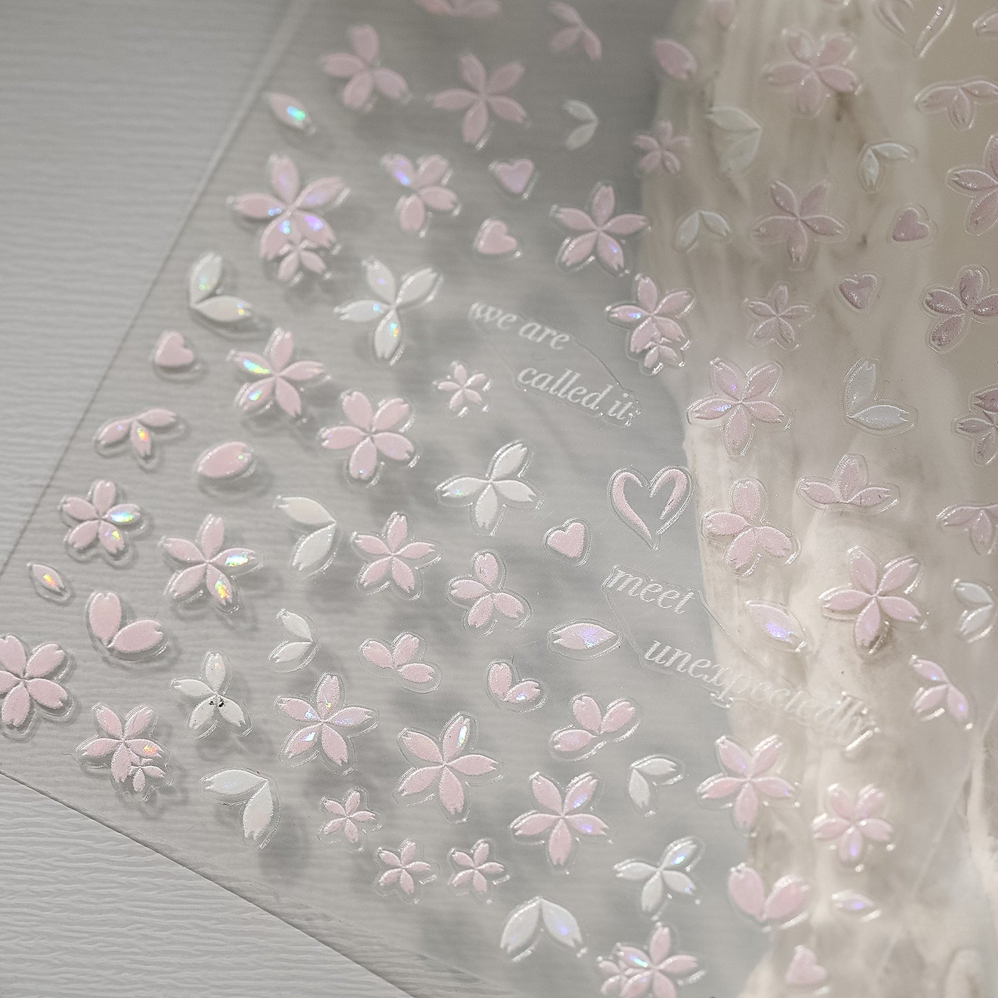 Sakura pink petal nail stickers with iridescent shell effect, close up look