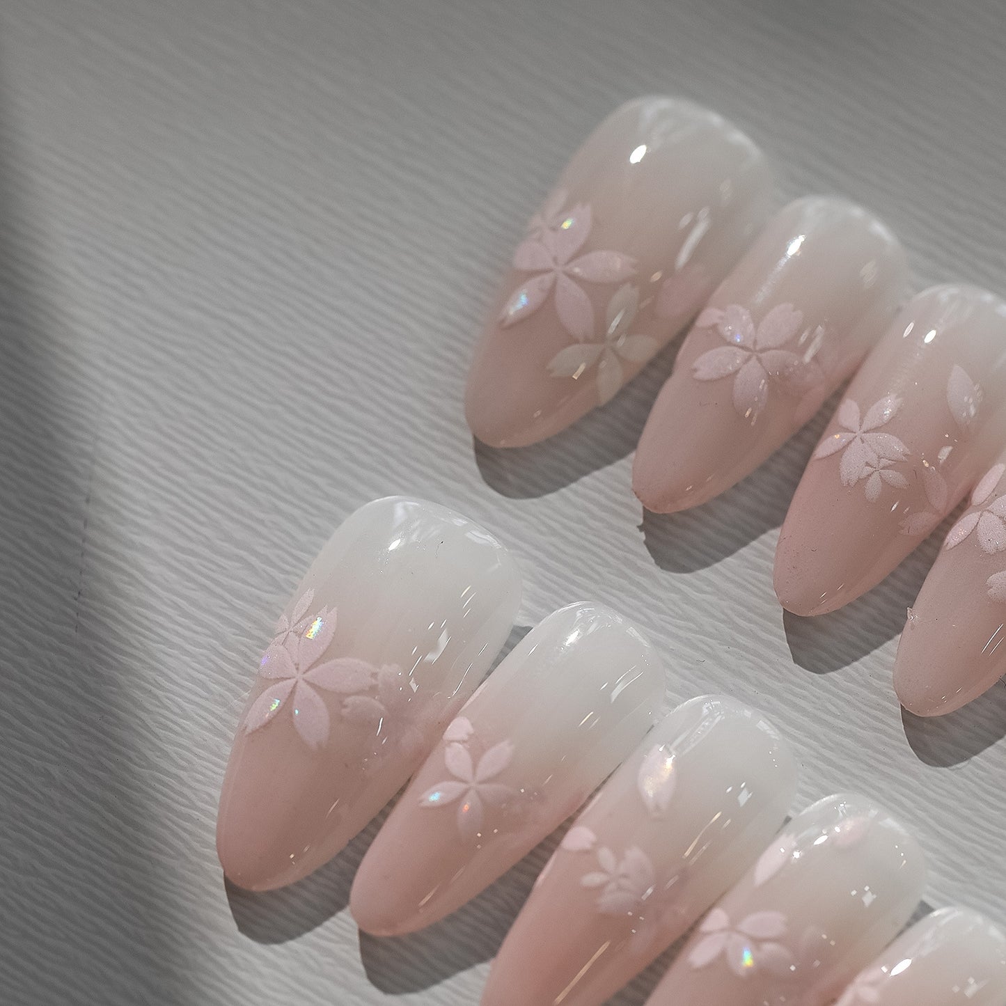 Sakura pink petal nail stickers with iridescent shell effect, close up look on press on nails