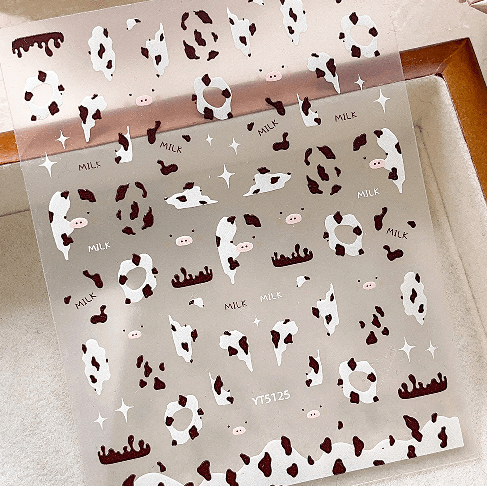 3D embossed cow print nail stickers in white and brown