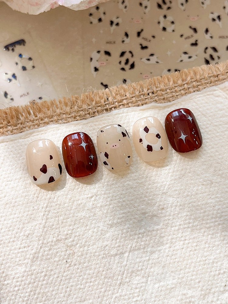 3D embossed cow print nail stickers in white and brown on press on nails
