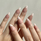 Fake nails on hand with a floral design on a neutral background. Set of coquette nail art designs with hand-painted pink floral patterns