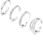 Set of four silver adjustable toenail rings with diamond accents on a white background. LuxeCharm press on nails.
