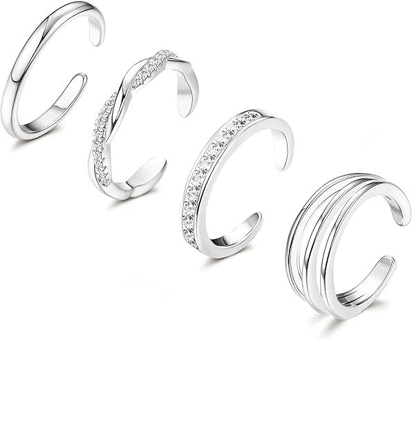 Set of four silver adjustable toenail rings with diamond accents on a white background. LuxeCharm press on nails.
