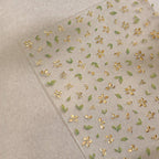 3D gold-foil floral nail stickers with metallic petals and leaves for DIY nail art, close up look angle 2