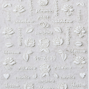 Decorative embossed paper with floral and text patterns on a light gray background. 5D luxury lace flower nail stickers. LuxeCharm