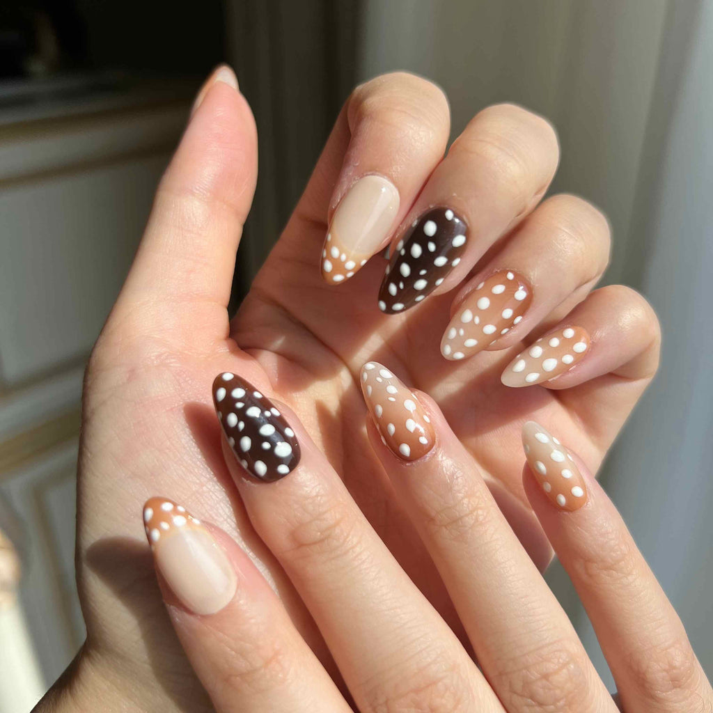 LuxeCharm Bambi Haze animal-inspired press-on nails styled on hand with a glossy short almond finish