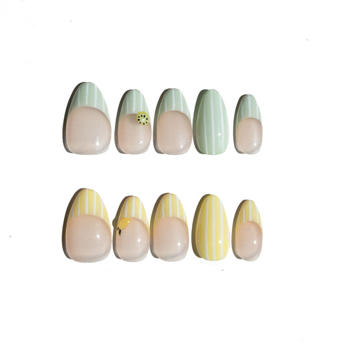 Set of nail art designs on a white background. Avocado green and white striped & yellow and white striped nail designs featuring 3D kiwi and lemon sculpted. LuxeCharm press on nails