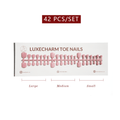 package of LuxeCharm toenails with product display and size labels on a white background. Cotton press-on toenails 42 piece set — off-white pedicure