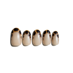 Set of five tortoiseshell patterned LuxeCharm press on nails on a white background