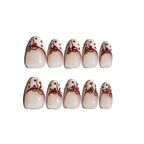 Set of LuxeCharm press on nails with red bow and polka dot designs on a white background. Ten LuxeCharm press on nails
