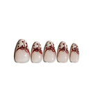 Five press on nails with red bow and polka dot design on a white background. LuxeCharm fake nails