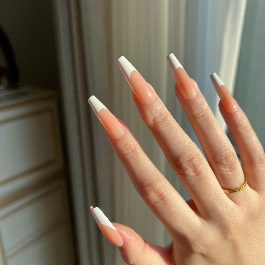 Close-up of a hand with LuxeTip French long coffin press on nails in light brown color