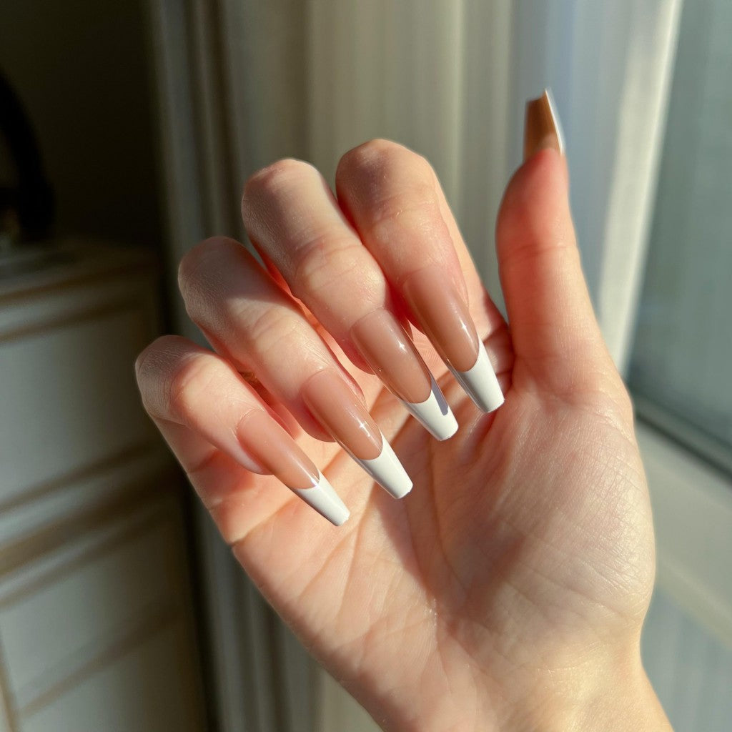 Hand with LuxeTip French long coffin press on nails in mocha color, in front of a window