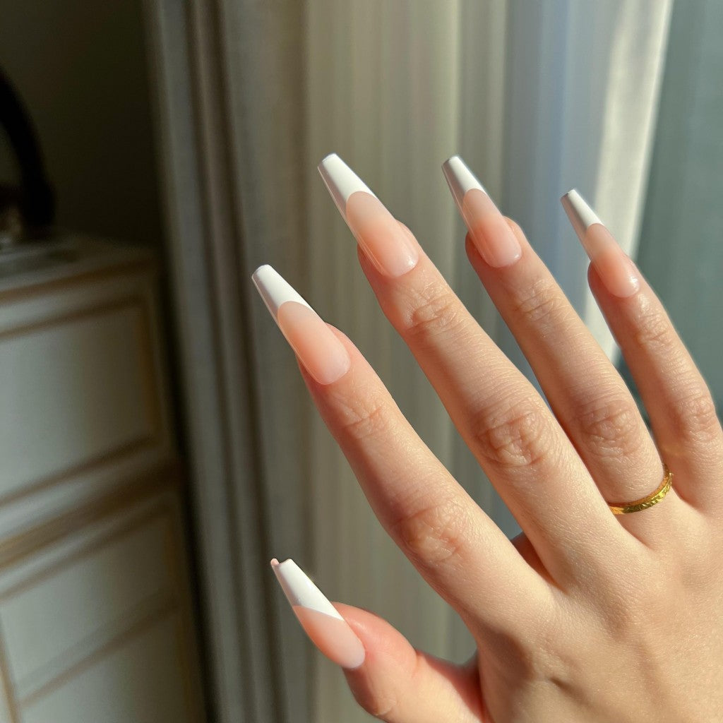 Hand with LuxeTip French long coffin press on nails in peach color