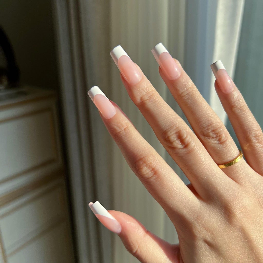Hand with LuxeTip French medium square press on nails in pink color on a neutral background