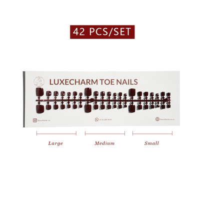 Display of LuxeCharm toe nails with size labels on a white background. Mocha press-on toenails 42 piece set — warm brown pedicure