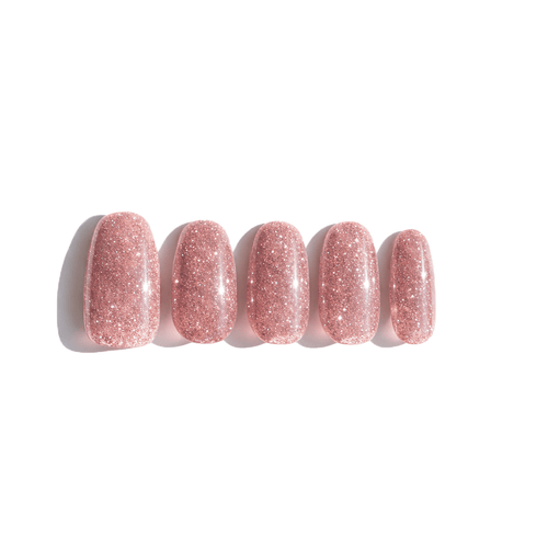 Set of five pink glitter nails on a white background. LuxeCharm press on nails