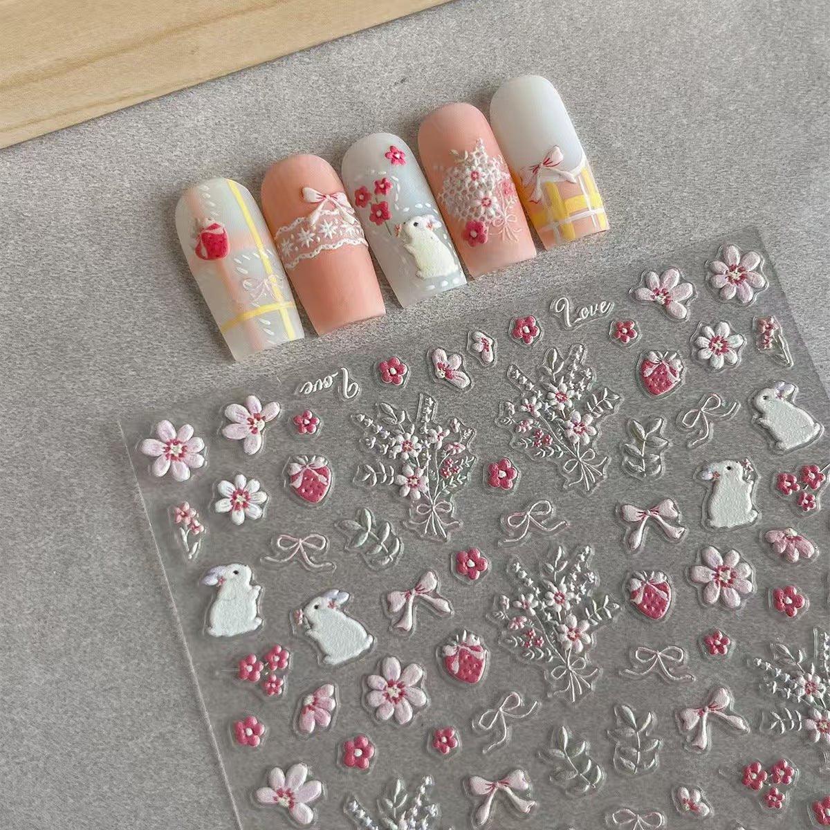 Nail art stickers with floral and decorative designs on a clear sheet. LuxeCharm nail stickers