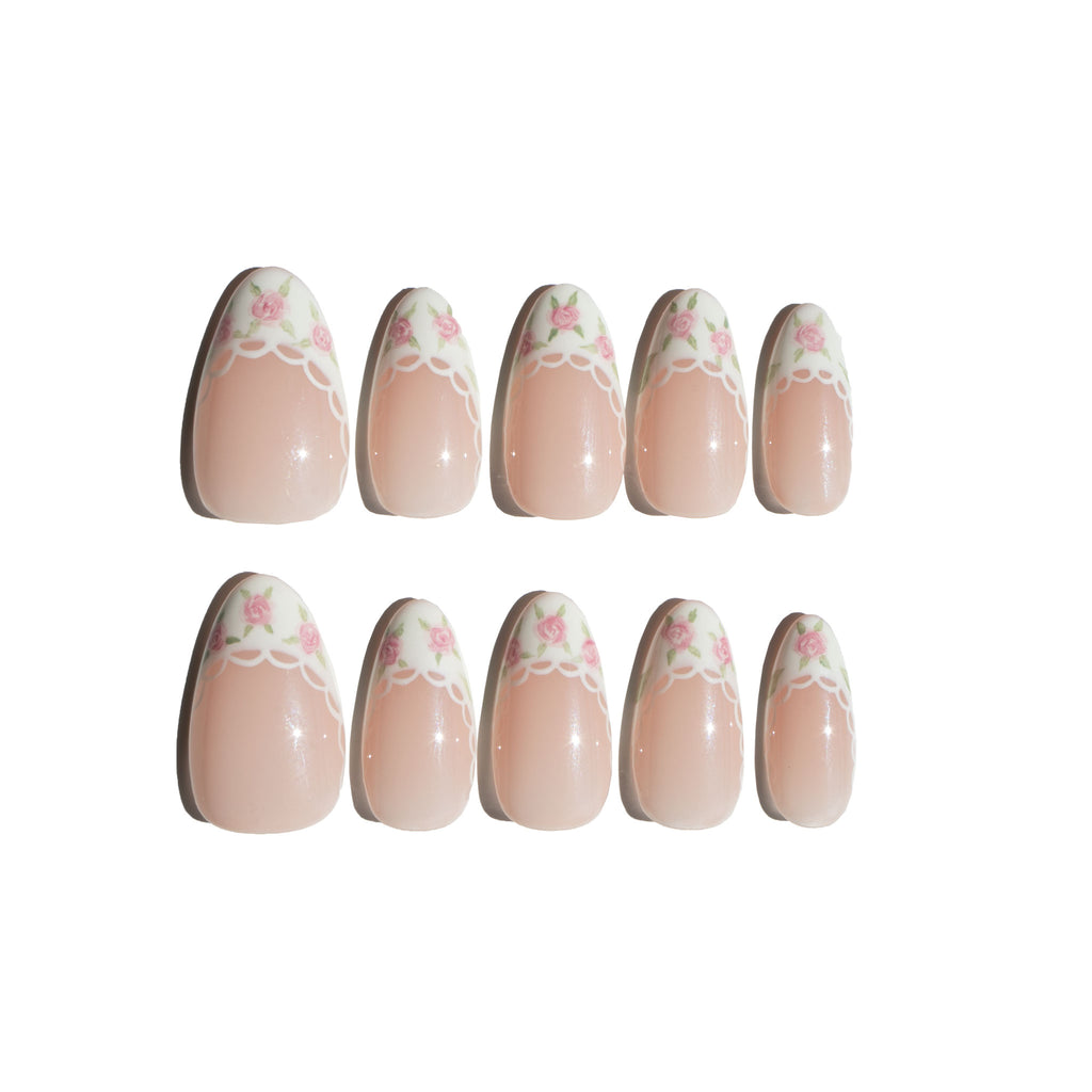 Set of coquette nail art designs with hand-painted pink floral patterns on a white background. LuxeCharm press on nails