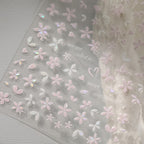 Sakura pink petal nail stickers with iridescent shell effect, close up look