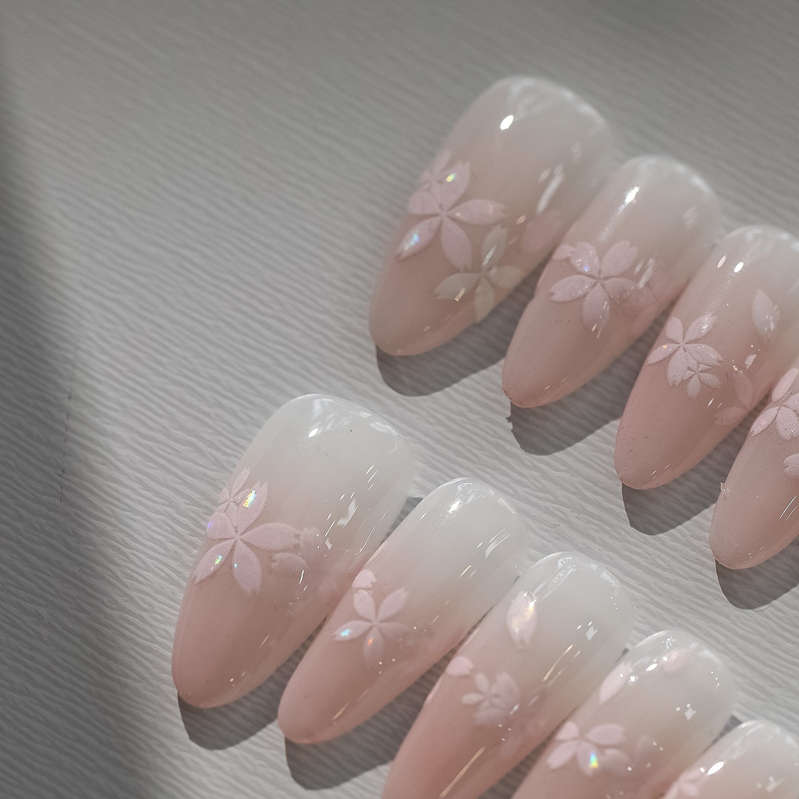 Sakura pink petal nail stickers with iridescent shell effect, close up look on press on nails