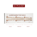 Packaging of LuxeCharm toe nails with size chart on a white background. Sand press-on toenails 42 piece set — warm nude pedicure