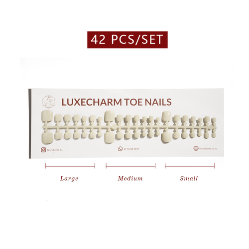 Set of LuxeCharm toe nails with size labels on a white background. Vanilla press-on toenails 42 piece set — creamy white pedicure