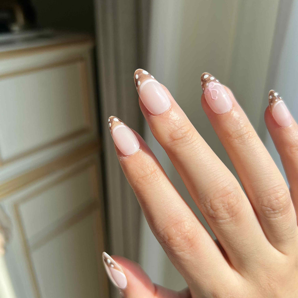 LuxeCharm Velvet Fawn nails on hand with extra short oval shape and soft deer-print details