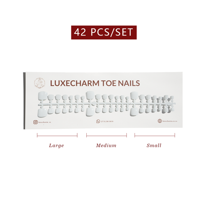 Set of LuxeCharm toe nails with size labels on a white background. White press-on toenails 42 piece set — crisp white pedicure