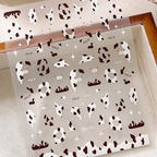 3D embossed cow print nail stickers in white and brown