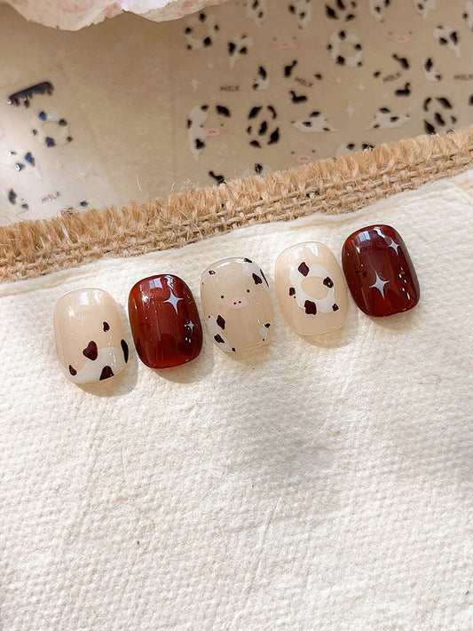 3D embossed cow print nail stickers in white and brown on press on nails
