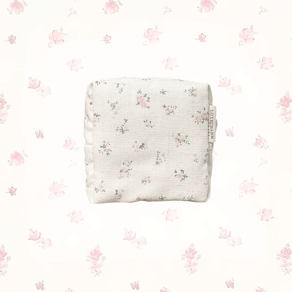 Pink Floral-patterned, handmade carry pouch on a white background with small floral designs. LuxeCharm Pouch