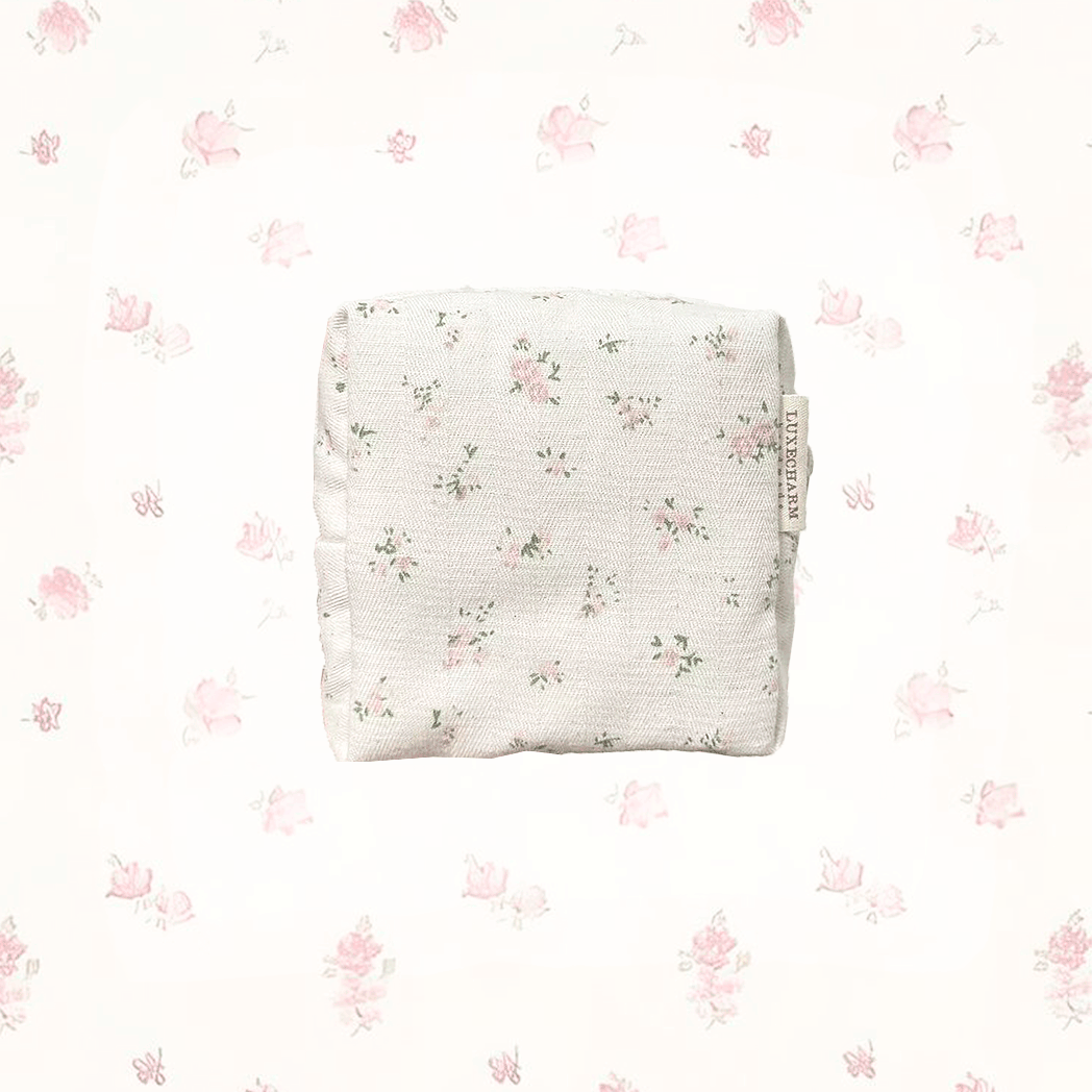 Pink Floral-patterned, handmade carry pouch on a white background with small floral designs. LuxeCharm Pouch