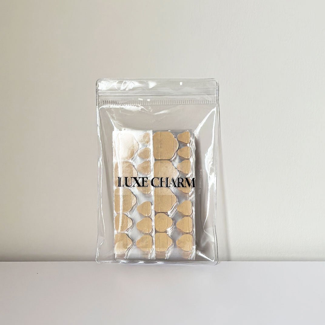 Clear packaging with sticky tabs pro for toes on a white background. LuxeCharm 